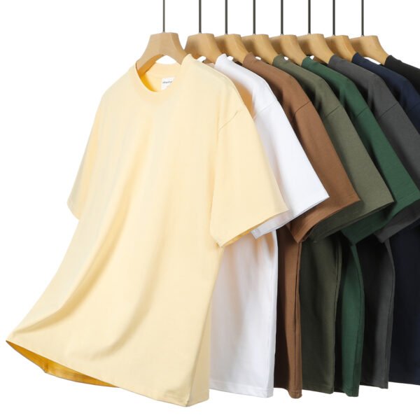Custom 320 GSM Oversized Cotton T-Shirt - Style E22B36 Several oversized t-shirts in different colors displayed on hangers