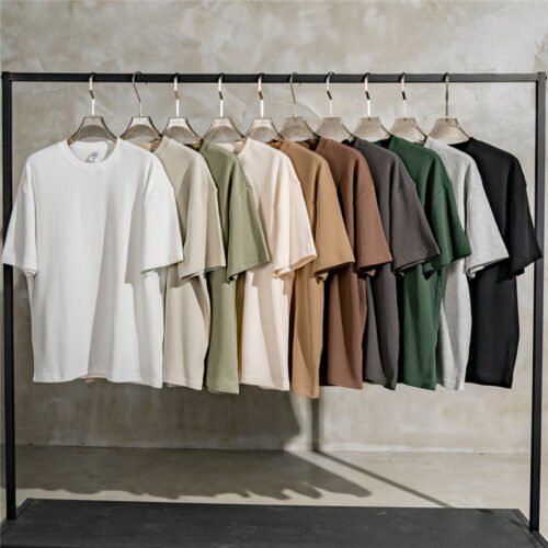 Multiple waffle knit crewneck t-shirts in various colors hanging on a rack.