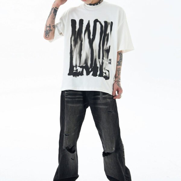 Custom Abstract Letter Graphic Streetwear T-Shirt - Style 97E0AD White oversized t-shirt with abstract black print and 'MADE ENTIRE' text