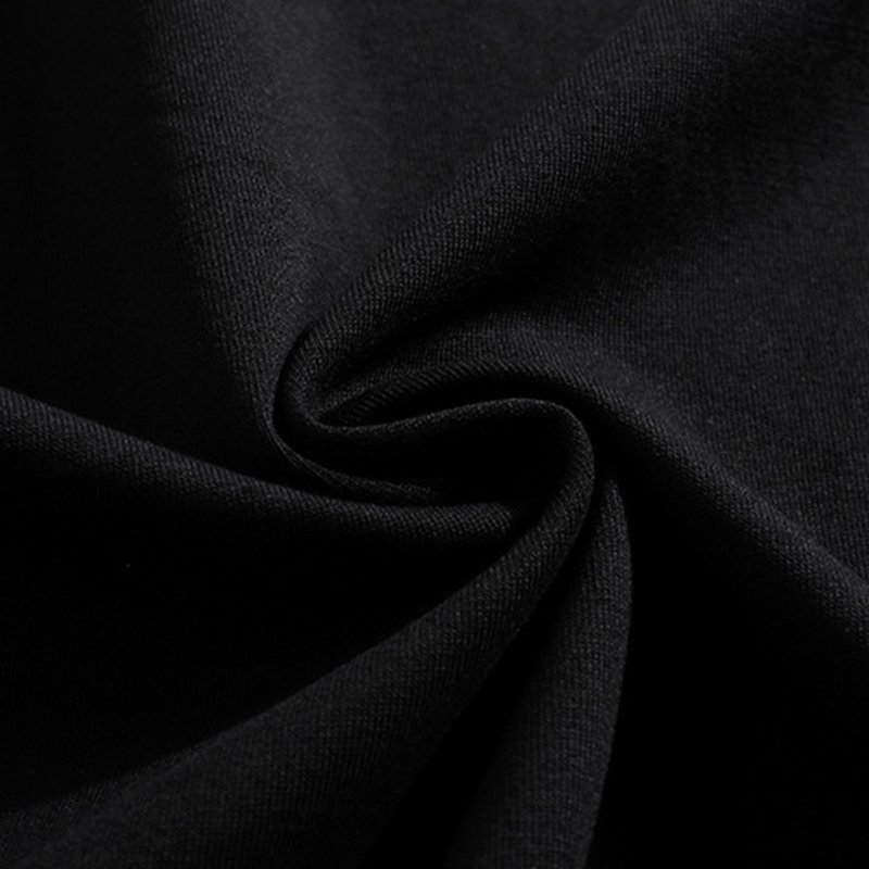 Close-up of the texture of a black acid-washed cotton fabric.