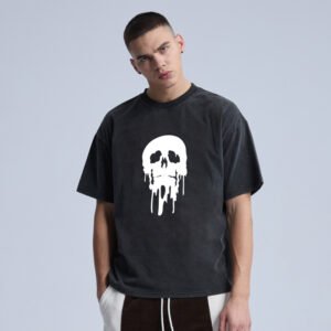 Man wearing a black acid-washed t-shirt with a white dripping skull graphic