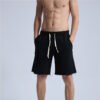 Man wearing black custom drawstring raw-hem streetwear shorts