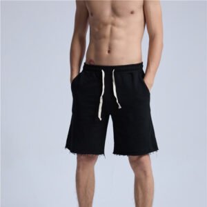 Man wearing black custom drawstring raw-hem streetwear shorts