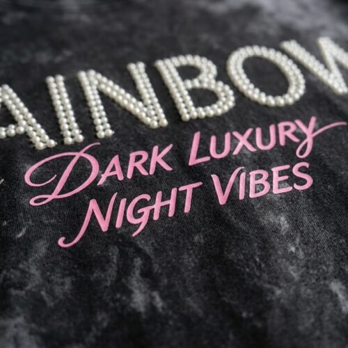 Custom acid-wash t-shirt with beaded rainbow and pink text.