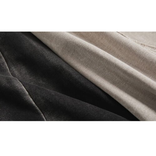 Close-up of a split patchwork t-shirt in black and beige.