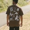 Custom Brown Back Graphic Oversized T-Shirt - Style B64EFC Brown oversized t-shirt with various tattoo-style graphics on the back