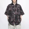 Man wearing a custom washed plaid patchwork button-front short-sleeve shirt