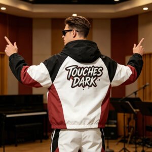 Man from behind wearing a color-block hooded jacket with 'TOUCHES DARK' graphic