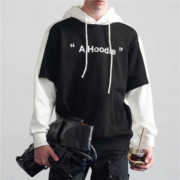 Man wearing a black and white layered hoodie with "A Hoodie" graphic