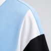 Custom Color-Block Screen Print Polo Shirt - Style CCBF9A Close-up of a custom color-block polo shirt with blue, white, and black panels.