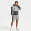 Man wearing a grey color-blocked zip hoodie and shorts set