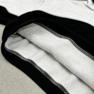 Close-up of the interior of a grey and black color block pullover hoodie