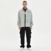 Light grey corduroy coach jacket with embroidered text
