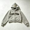 Grey cropped boxy zip hoodie with 'CUSTOM' applique