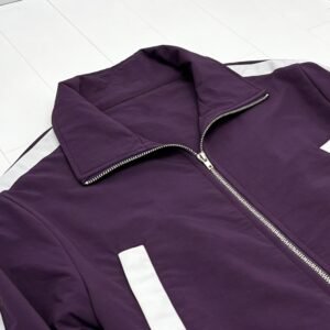 Close-up of a purple and white paneled zip-front track jacket