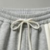 Custom Fleece-Lined Cropped Streetwear Jogger Pants - Style 565263 Close-up of grey jogger pants with a drawstring waist