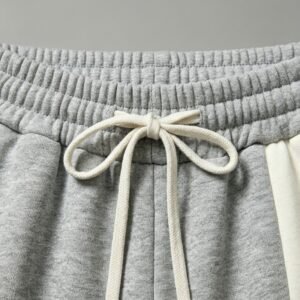 Close-up of grey jogger pants with a drawstring waist