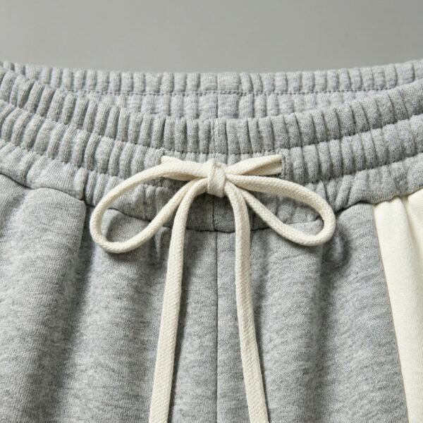 Custom Fleece-Lined Cropped Streetwear Jogger Pants - Style 565263 Close-up of grey jogger pants with a drawstring waist
