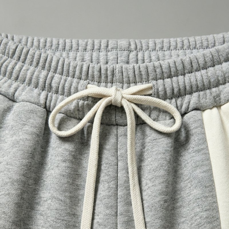 Close-up of grey jogger pants with a drawstring waist