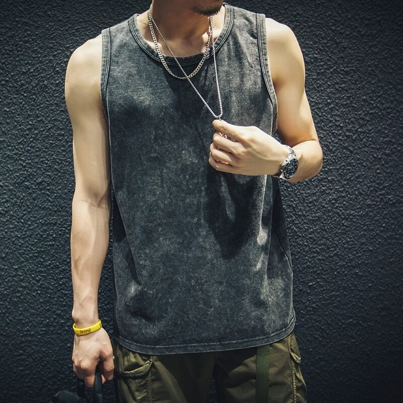 Man wearing a dark wash oversized sleeveless tank top