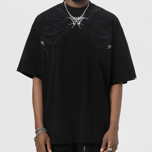 Man wearing a black oversized t-shirt with a geometric graphic design