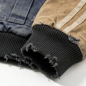 Close-up of distressed ribbed cuffs on a blue and tan baseball jacket.