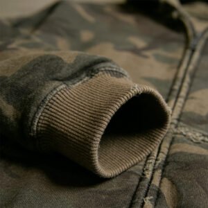 Close-up of a distressed camouflage pullover hoodie sleeve and zipper.