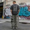 Custom Distressed Camouflage Wide-Leg Pants - Style 7B0CBD Man wearing distressed grey camouflage wide-leg pants with rips.