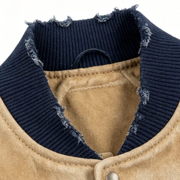 Close-up of a distressed navy blue ribbed knit collar on a tan jacket.