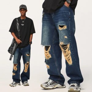 Man wearing distressed loose-fit blue denim jeans with rips