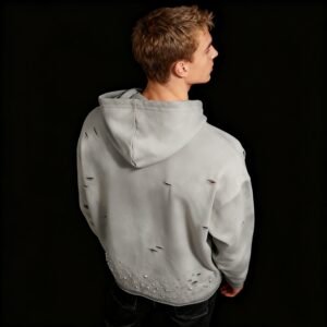 Man wearing a grey distressed acid wash pullover hoodie with rhinestones