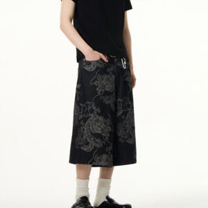 Man wearing black denim long shorts with a dragon pattern