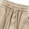 Close-up of relaxed fit drawstring pants in khaki
