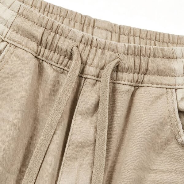 Close-up of relaxed fit drawstring pants in khaki