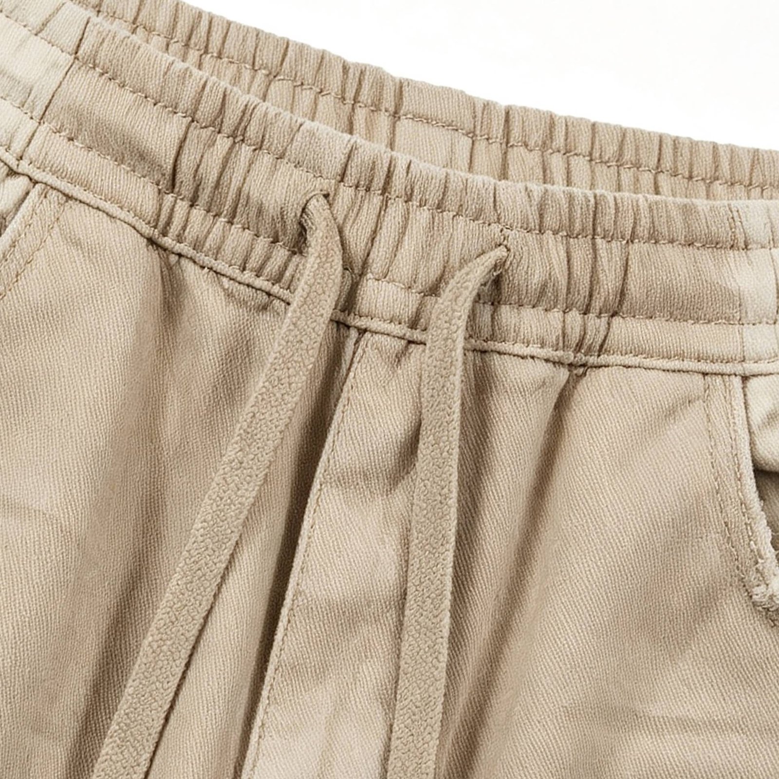 Close-up of relaxed fit drawstring pants in khaki