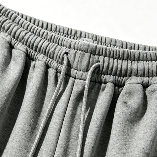 Close-up of grey elastic waist pants with drawstring