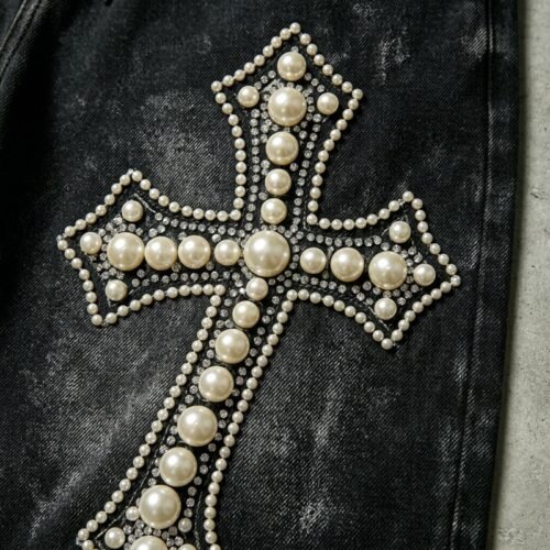 Close-up of custom embellished cropped denim capri jeans with pearl cross