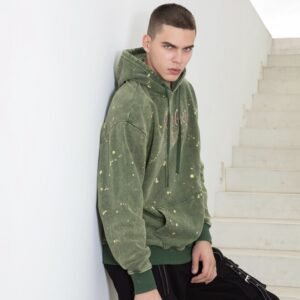 Mens green acid wash pullover hoodie with paint splatter detail