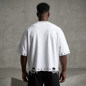 White oversized t-shirt with distressed eyelet details on the sleeves and hem