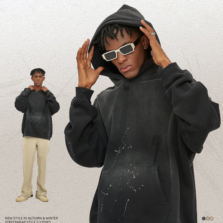 Oversized black zip hoodie with spray finish details.