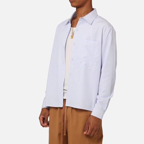 Man wearing a light blue and white striped long-sleeve overshirt