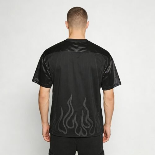 Black streetwear jersey with flame graphic detail on the lower back.
