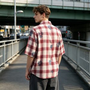 Man wearing a red and white plaid short-sleeve shirt with floral accents