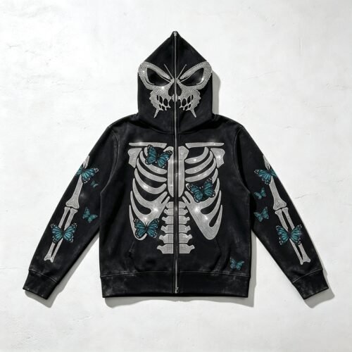 Black distressed full-zip hooded jacket with skeleton and butterfly rhinestone graphics.
