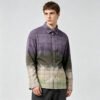 Man wearing a purple to green gradient plaid long-sleeve shirt