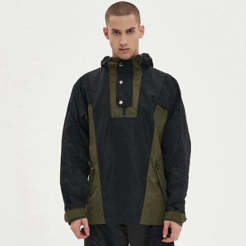 Man wearing a black and olive green two-tone half-zip anorak jacket