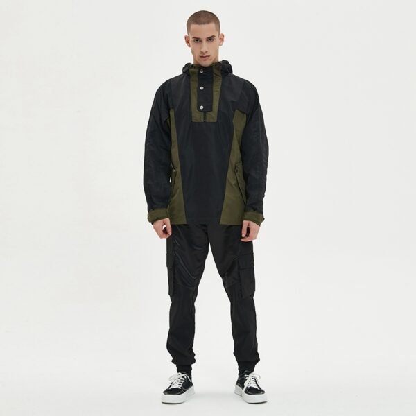 Man wearing a black and olive green custom half-zip anorak windbreaker