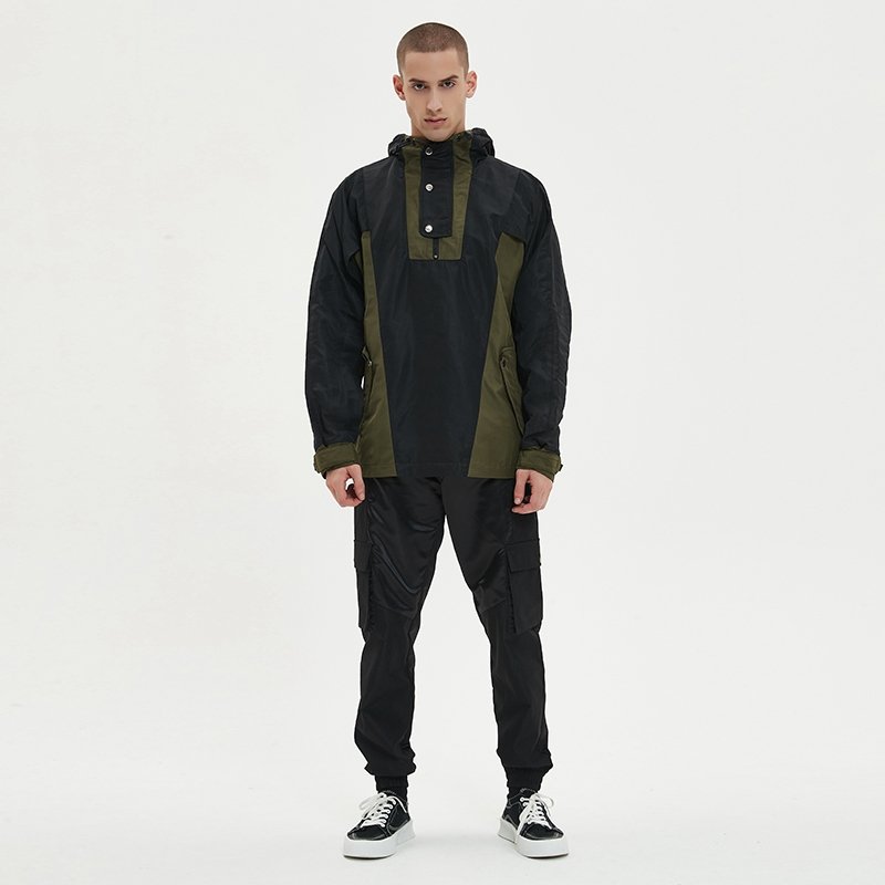 Man wearing a black and olive green custom half-zip anorak windbreaker