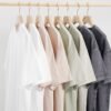 Custom heavyweight cotton t-shirts in various neutral colors hanging on a rack.