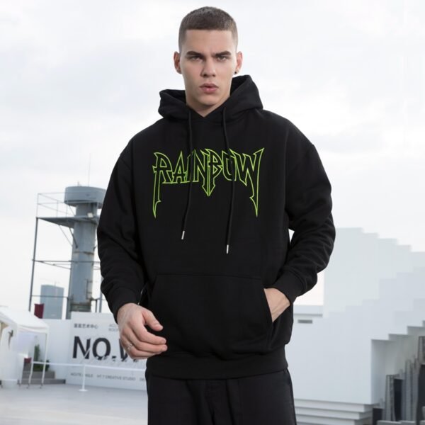 Man wearing a black heavyweight hoodie with a neon green graphic